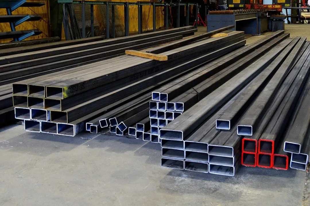 Steel box sections stacked in a yard