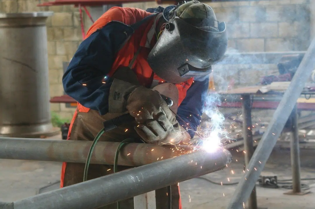 Welder at work on a steel pipe